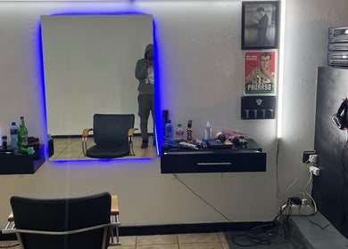 Modern styling station at Darthfader031, Roodepoort, Gauteng, ZA, featuring sleek mirror and barber tools.