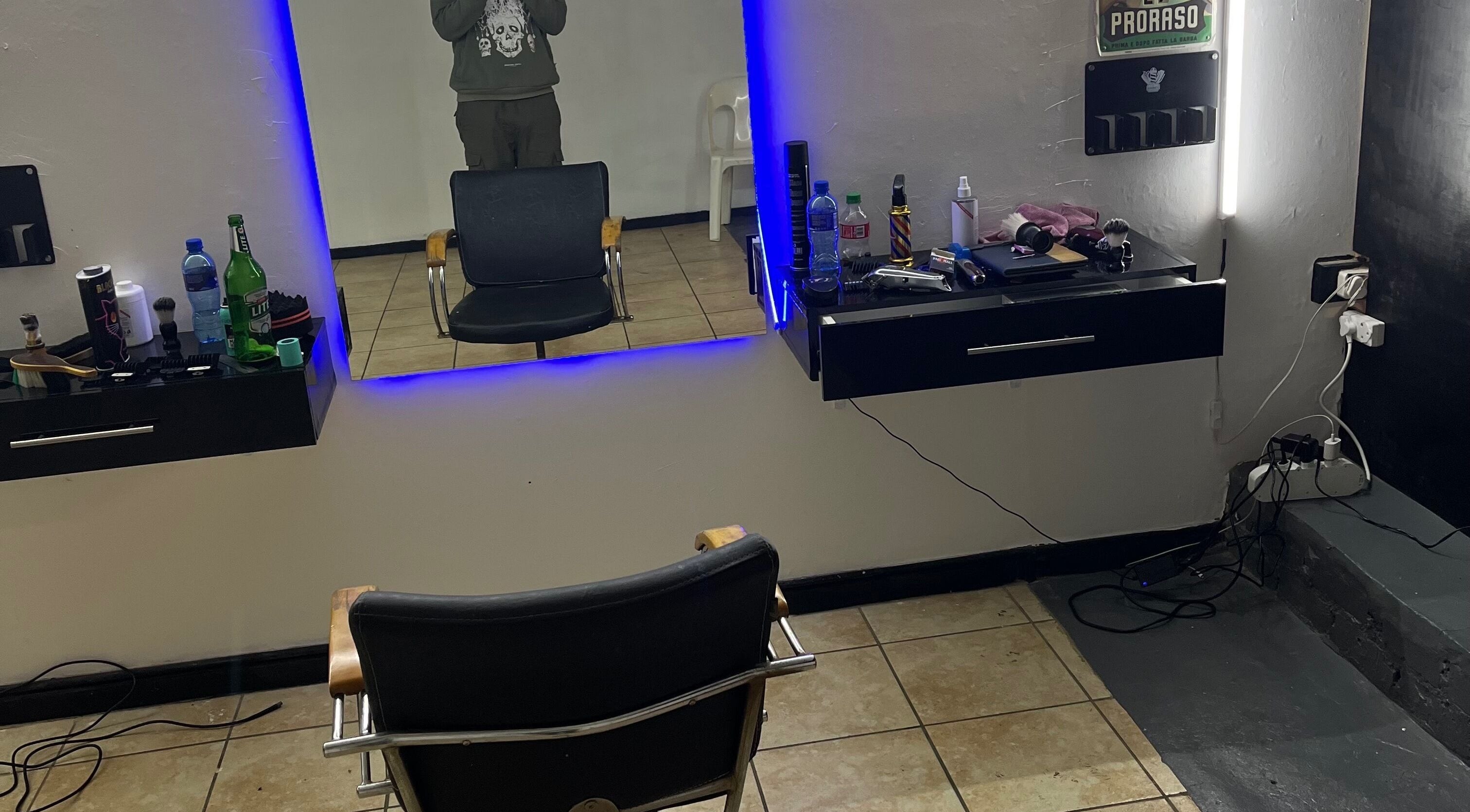 Modern grooming station at Darthfader031, Roodepoort, Gauteng, ZA with sleek chairs and illuminated mirror.