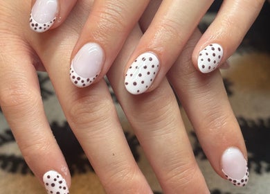 Elegant polka-dot nail art at Nella Beauty, Oldbury, England, GB. Perfect for modern style.