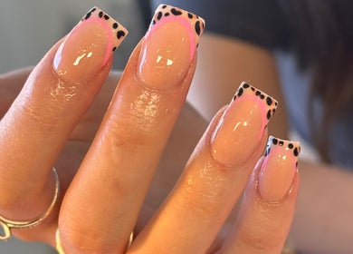 Nella Beauty in Oldbury, England offers chic leopard print nail art with pink accents.