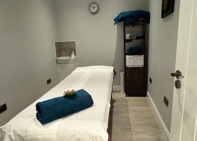 Relaxing massage room at Na Siam Spa, London, England, GB with a massage table and calming decor.