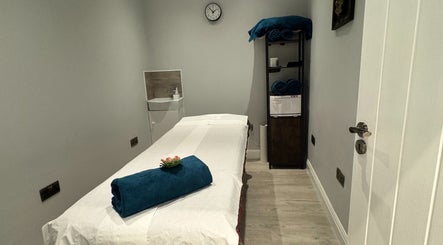 Relaxing massage room at Na Siam Spa, London, England, GB with a massage table and calming decor.
