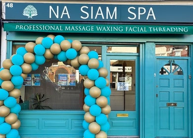 Na Siam Spa entrance adorned with teal and gold balloons, London, England, GB.