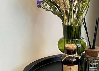 Elegant aromatherapy setup at Brows.And.Skincare.Riga in Rīga, LV features a vase and fragrant oils.