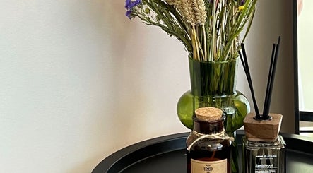 Elegant aromatherapy setup at Brows.And.Skincare.Riga in Rīga, LV features a vase and fragrant oils.