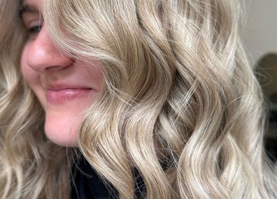 Soft golden waves hairstyle at Mirren Wordie Hair, Stirling, GB. Captures elegance and style by expert stylists.