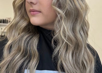 Elegant blonde curls styled at Mirren Wordie Hair, Stirling, GB. Beautiful wavy hairstyle for a chic look.