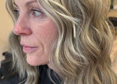 Close-up of wavy blonde hair styled at Mirren Wordie Hair, Stirling, GB, showcasing natural elegance.