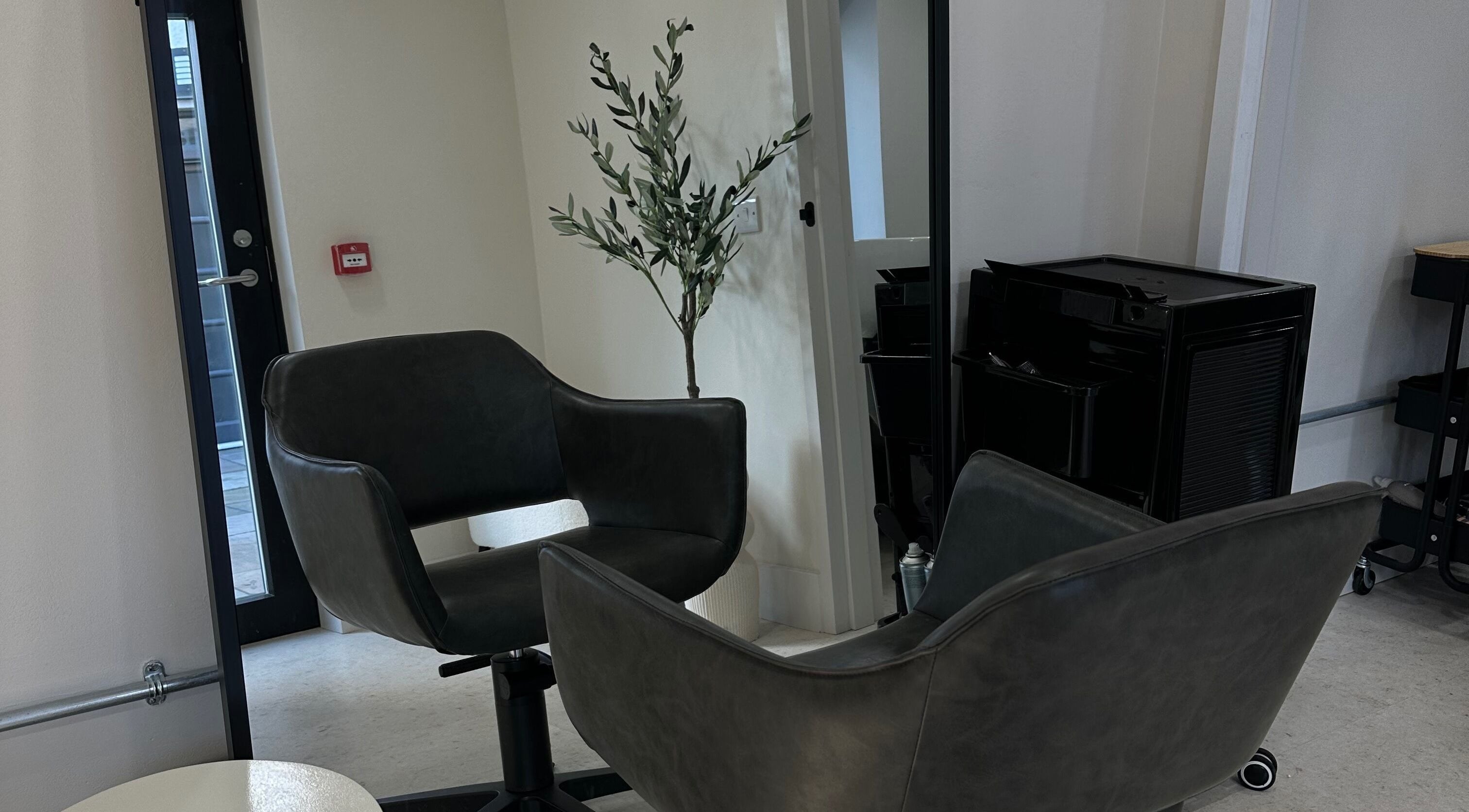 Modern salon chair with mirror at Mirren Wordie Hair, Stirling, Scotland, GB, showcasing sleek design.