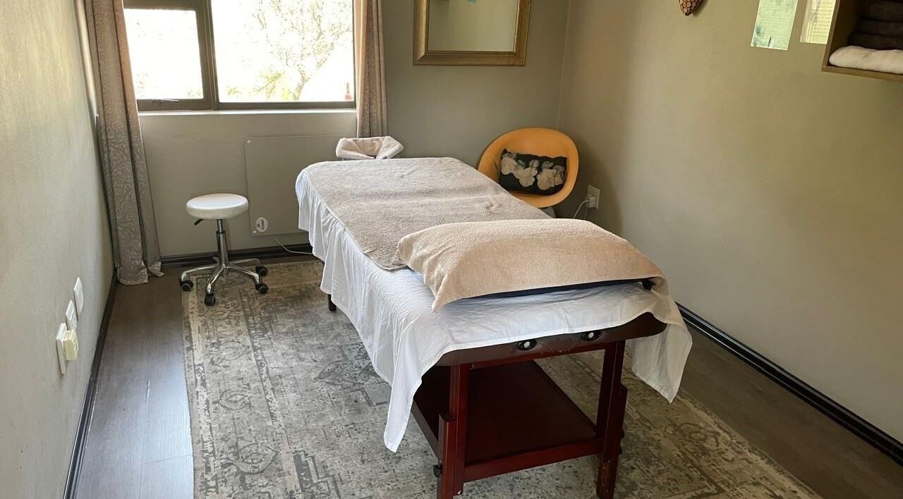 Cozy massage room at Massage by Rich, Randburg, Gauteng, ZA with a massage table and chair.