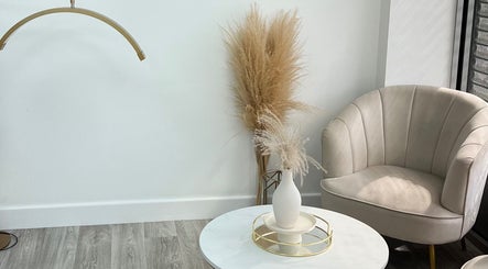 Elegant seating area at Tabitha Tweaks, Skelmersdale, England, GB featuring a plush chair and stylish decor.