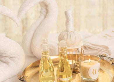 Luxury spa setting at RUT SPA, Al Khobar, Eastern Province, SA with oils and candle on golden tray.