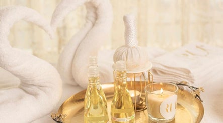 Luxury spa setting at RUT SPA, Al Khobar, Eastern Province, SA with oils and candle on golden tray.