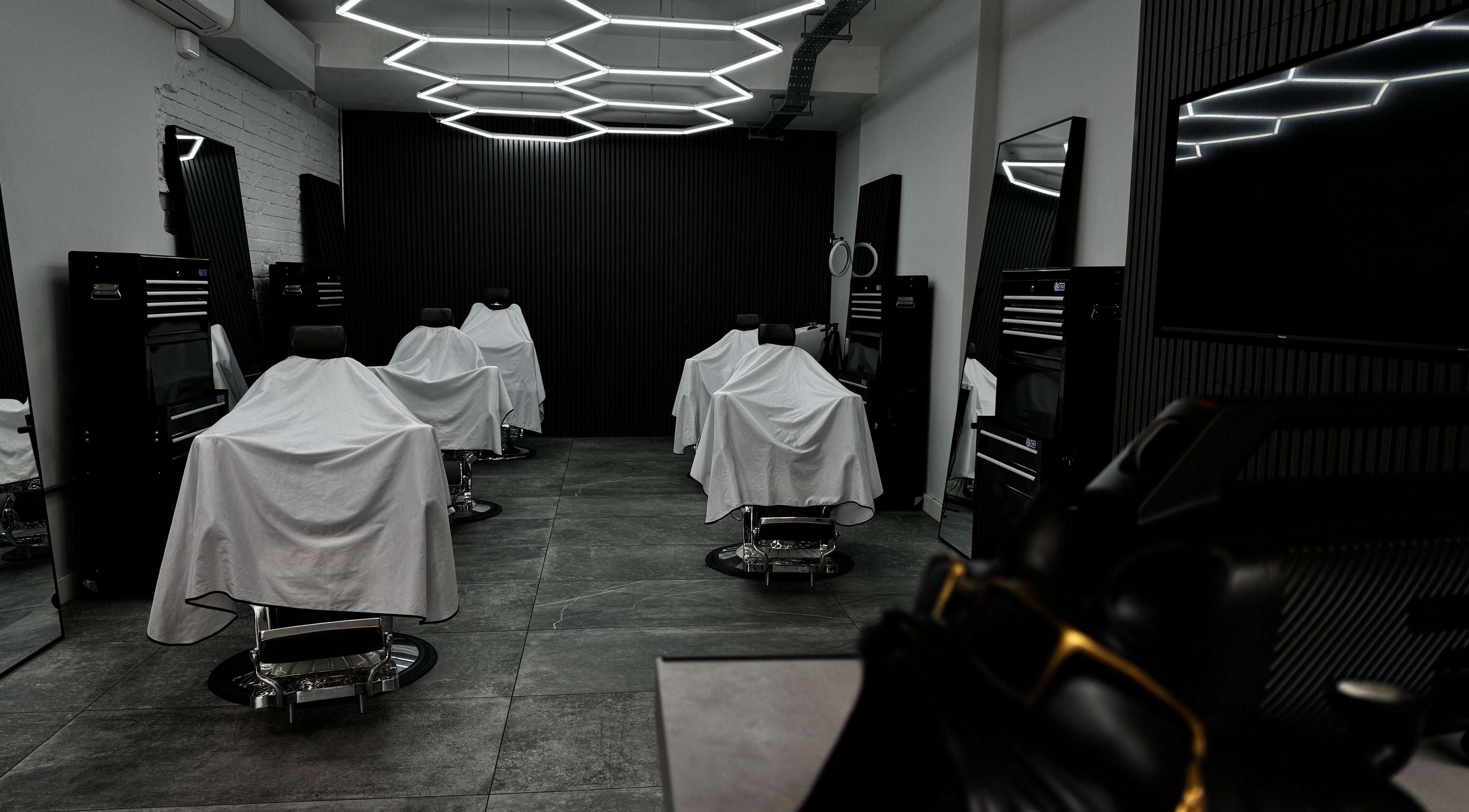 Modern barber chairs at Barberesso, a chic barbershop in London, England, GB, showcasing contemporary elegance.