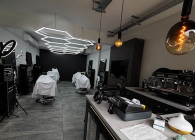 Sophisticated interior of Barberesso in London, England, GB, featuring modern barber chairs and sleek design elements.