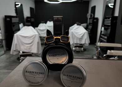 Stylish Barberesso interior in London, England with grooming products and classic chairs.