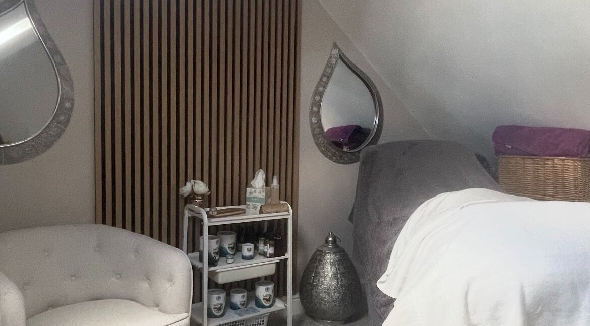 Cozy therapy room at River Holistic Therapies, Nursling, England, GB with plush seating and tranquil decor.