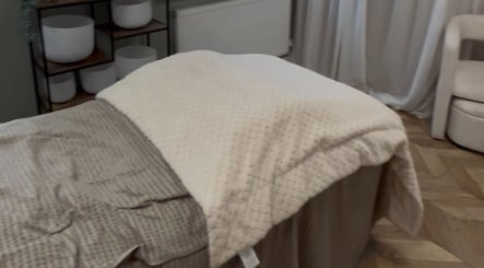 Cozy massage bed setup at Bykiraquigley, Manchester, England, GB, offering a serene relaxation space.