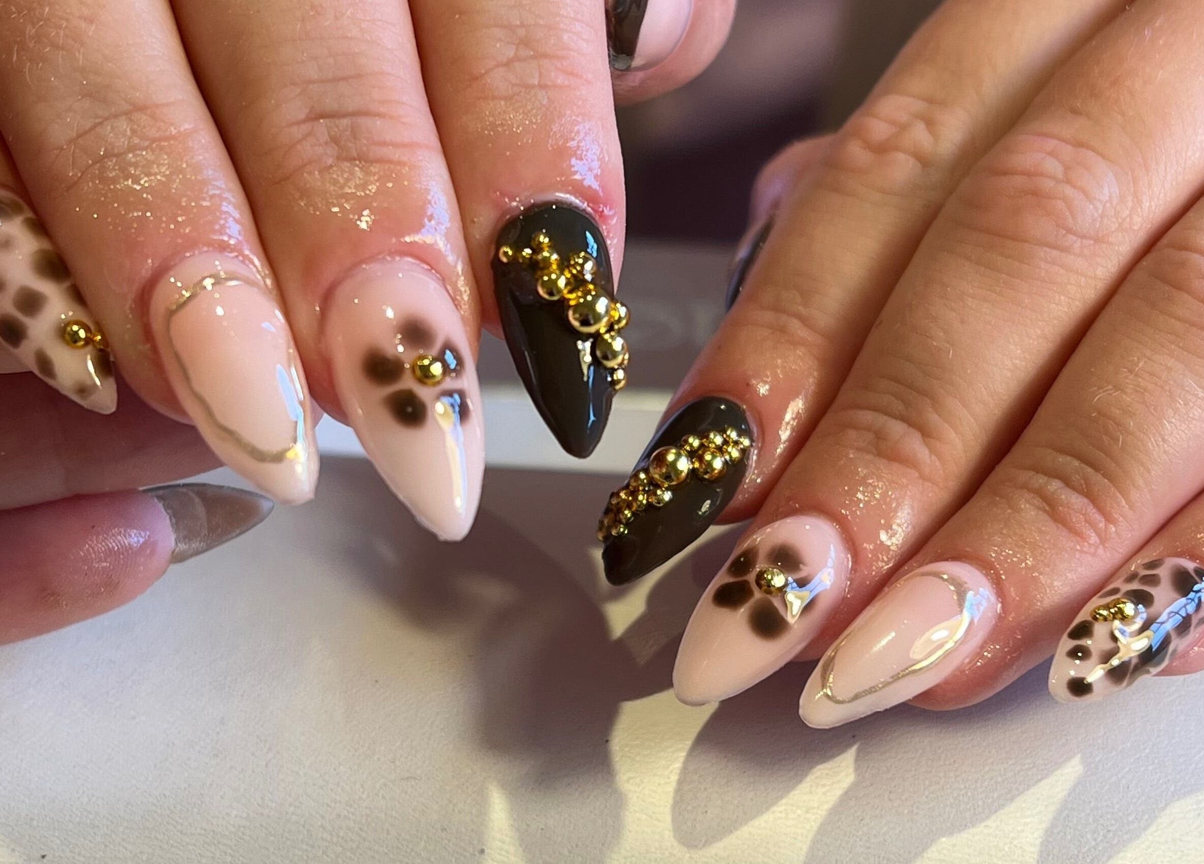 Stylish nail art with gold accents at The Nail Studio By Kim, Leek, England, GB.