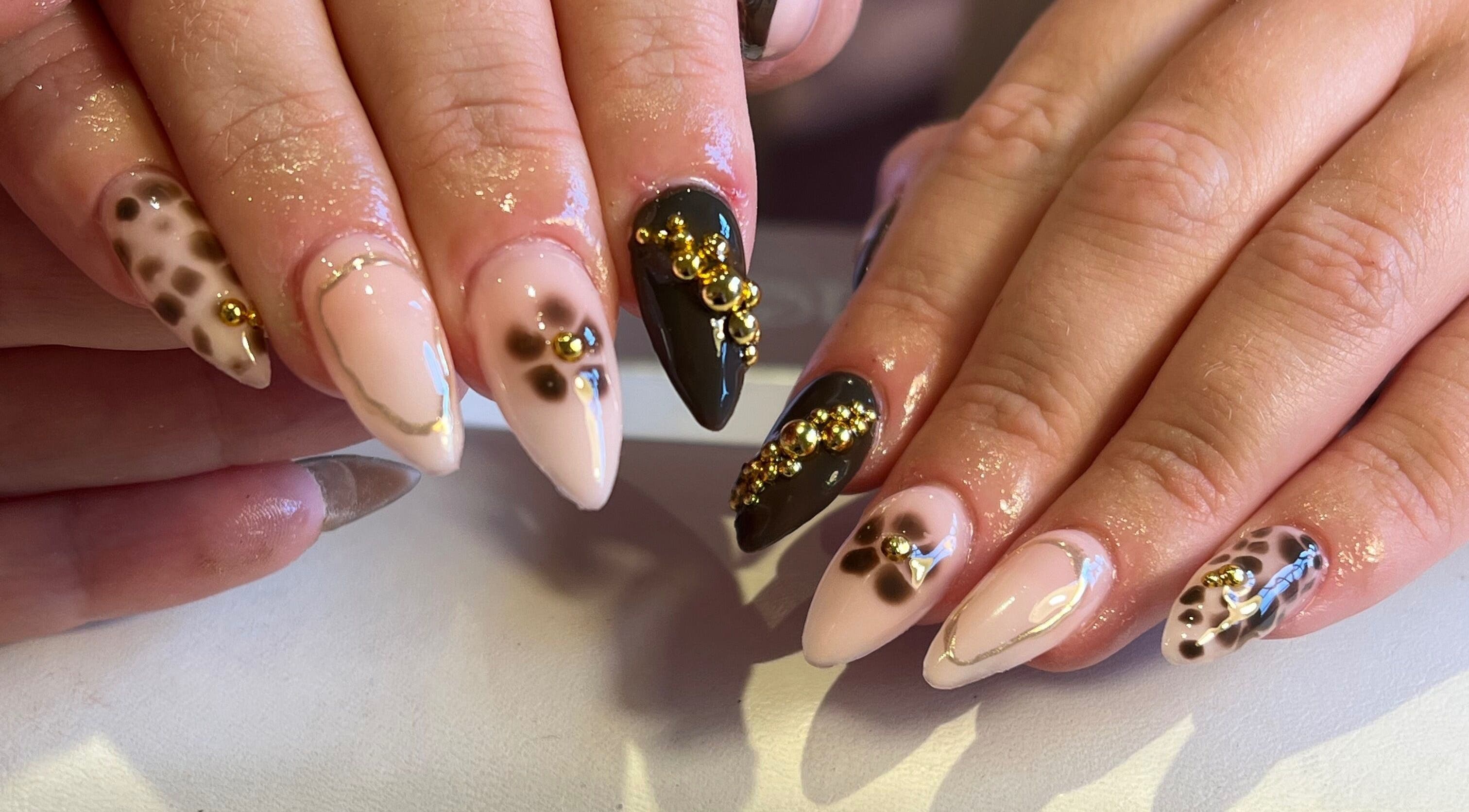 Stylish nail art with gold accents at The Nail Studio By Kim, Leek, England, GB.