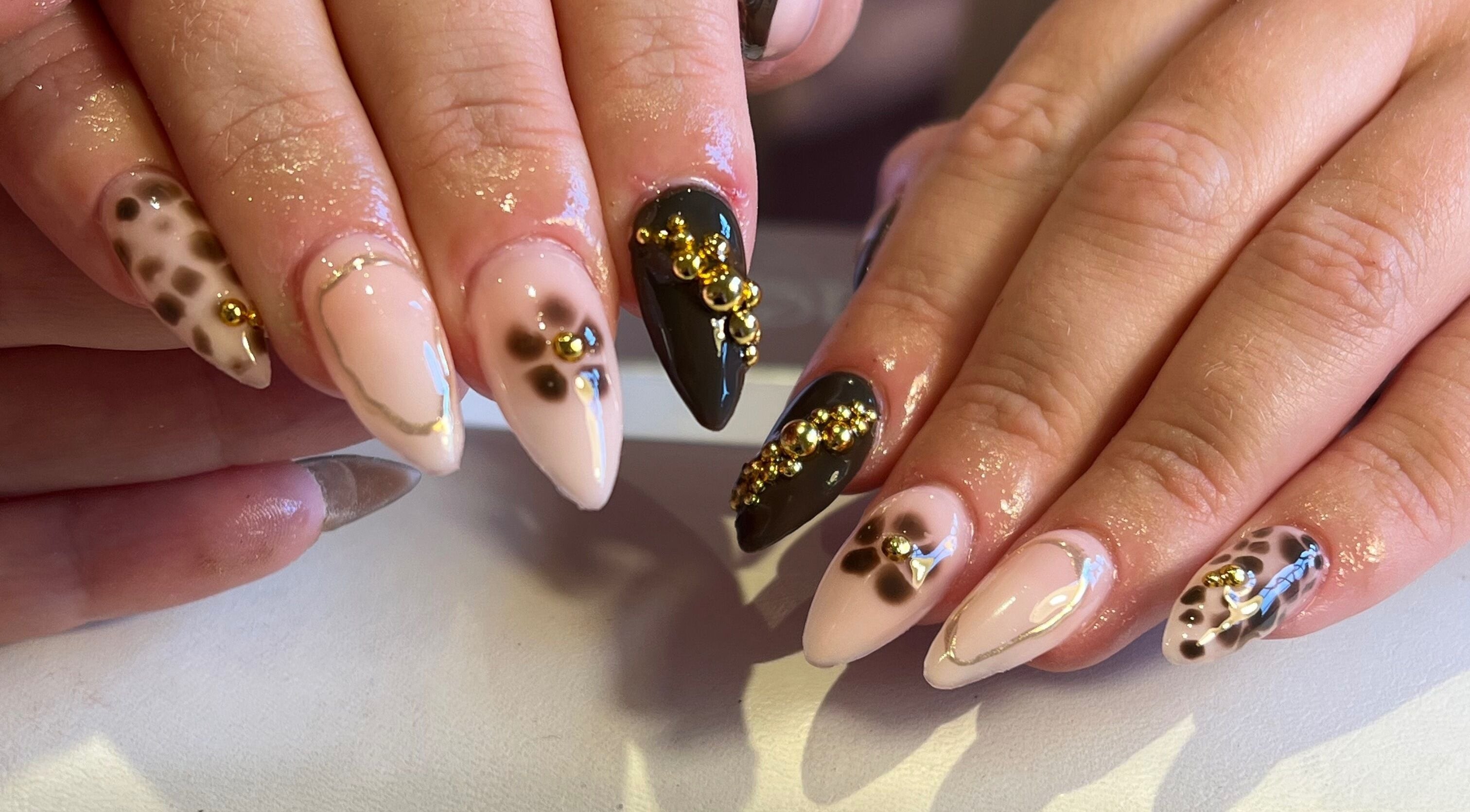 Stylish nail art with gold accents at The Nail Studio By Kim, Leek, England, GB.
