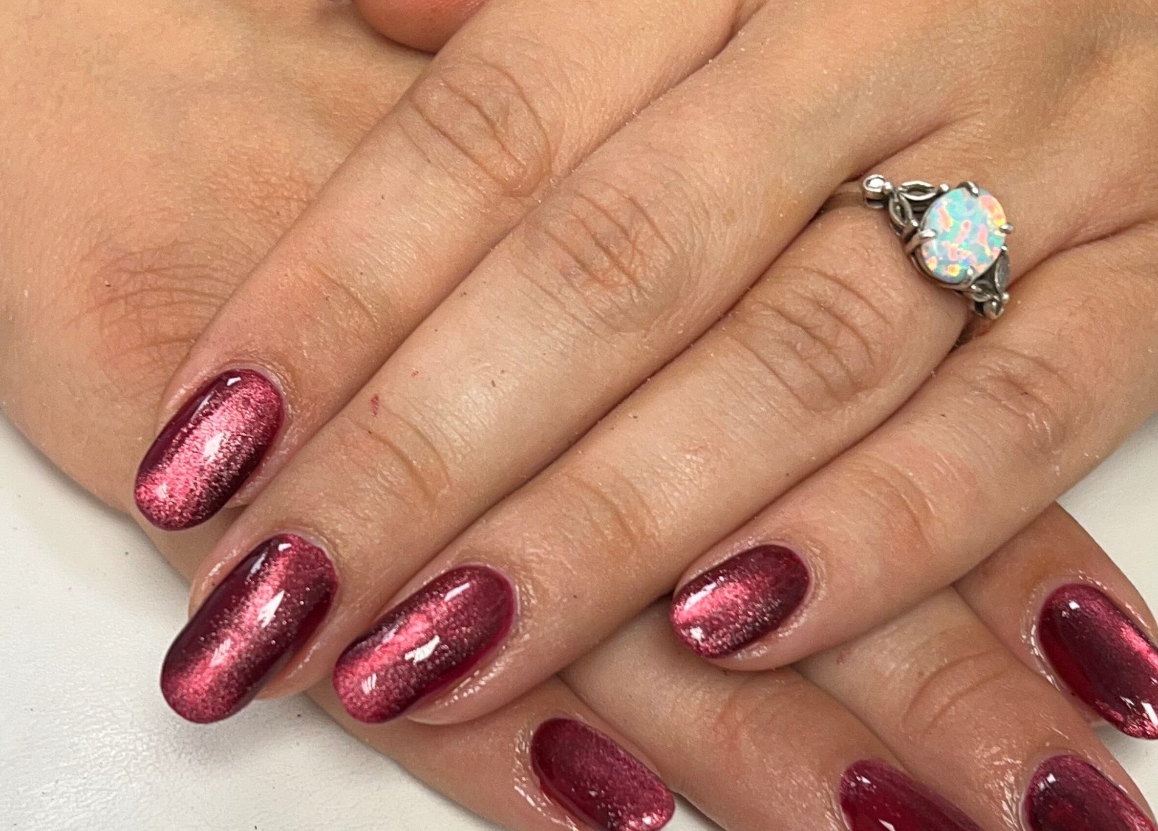 Gleaming ruby nails at The Nail Studio By Kim, located in Leek, England, GB, showcasing expert manicure.