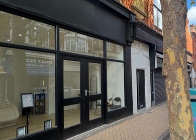 Front view of Dolls beauty lab in Bournemouth, England, GB showcasing modern glass facade.