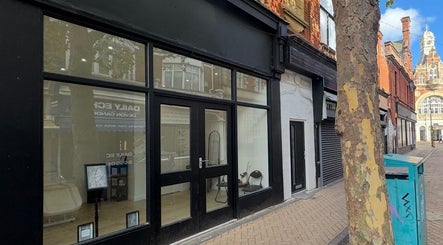 Front view of Dolls beauty lab in Bournemouth, England, GB showcasing modern glass facade.