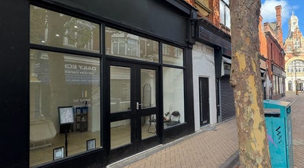 Street view of Dolls beauty lab in Bournemouth, England, GB. Glass-fronted exterior with modern decor.