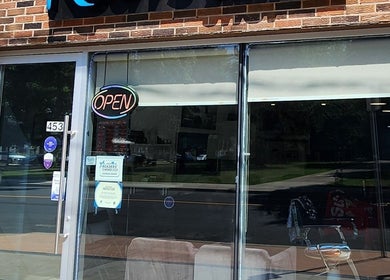 Front entrance of RCutsBarberShop, Hamilton, Ontario, CA, featuring an inviting open sign.