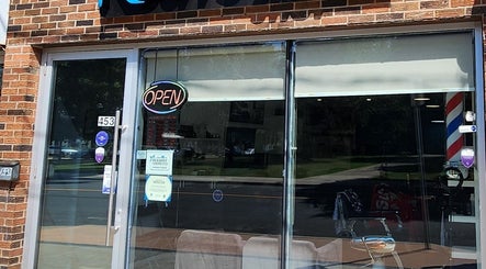 Front entrance of RCutsBarberShop, Hamilton, Ontario, CA, featuring an inviting open sign.
