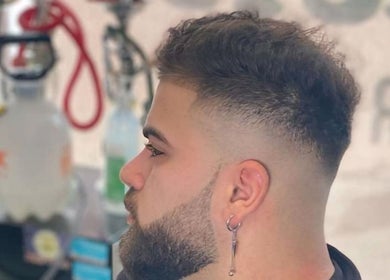 Client with a fresh fade haircut at RCutsBarberShop, Hamilton, Ontario, CA, showcasing expert grooming.