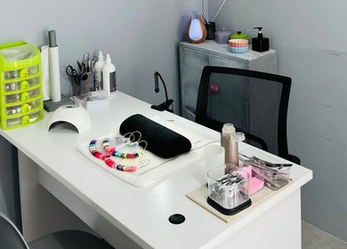 Professional nail workstation at Melovely Beauty Salon, Jeffreys Bay, Eastern Cape, ZA, showcasing tools and polish.
