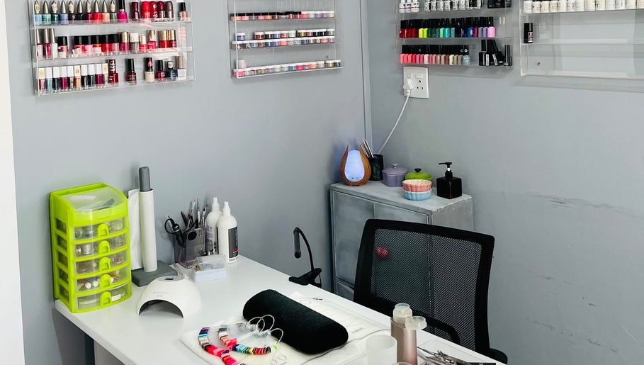 Nail art station at Melovely Beauty Salon, Jeffreys Bay, Eastern Cape, ZA, showcasing polish and manicure tools.