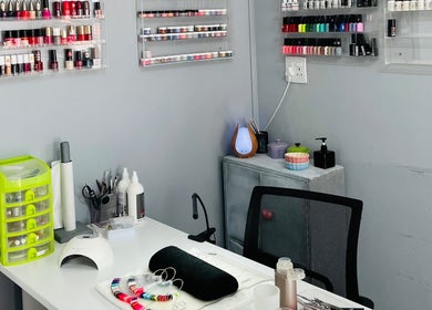 Nail art station at Melovely Beauty Salon, Jeffreys Bay, Eastern Cape, ZA, showcasing polish and manicure tools.