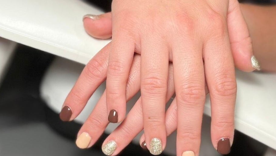 Elegant manicure at Nails at the Barn, Earls Colne, England, GB featuring brown and gold shades.