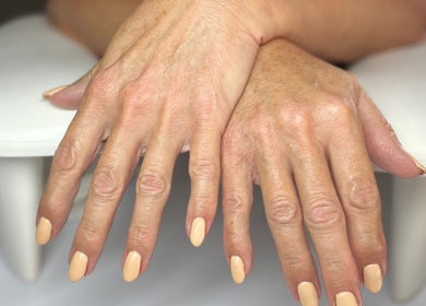 Manicured hands with nude polish at Nails at the Barn, Earls Colne, England, GB.