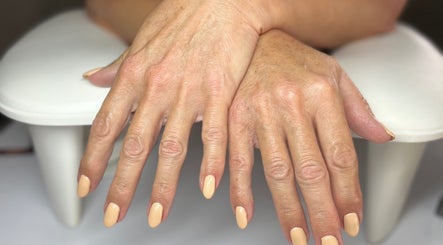 Manicured hands with nude polish at Nails at the Barn, Earls Colne, England, GB.
