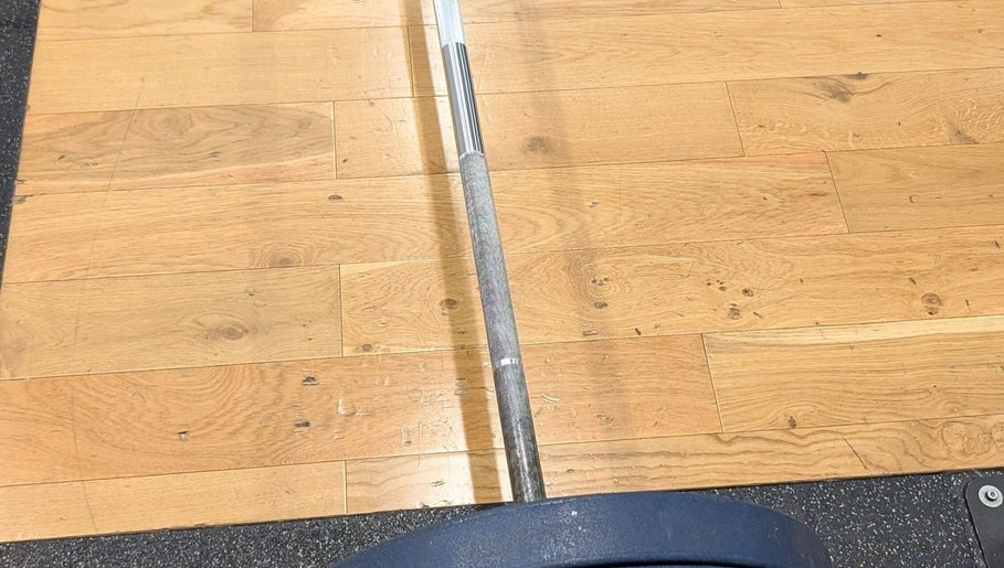 Barbell on a wooden floor at Burn With Jeff - Personal Training, Stretford, England, GB.