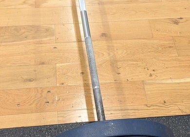 Powerlifting barbell on wooden floor at Burn With Jeff - Personal Training, Stretford, England, GB.