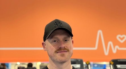 Trainer at Burn With Jeff - Personal Training, Stretford, England, GB, with orange heart-themed background.