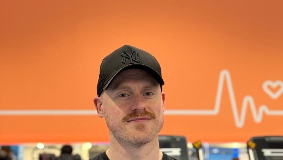 Trainer at Burn With Jeff - Personal Training in Stretford, England, GB with heart-themed backdrop.