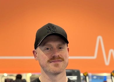 Trainer at Burn With Jeff - Personal Training in Stretford, England, GB with heart-themed backdrop.