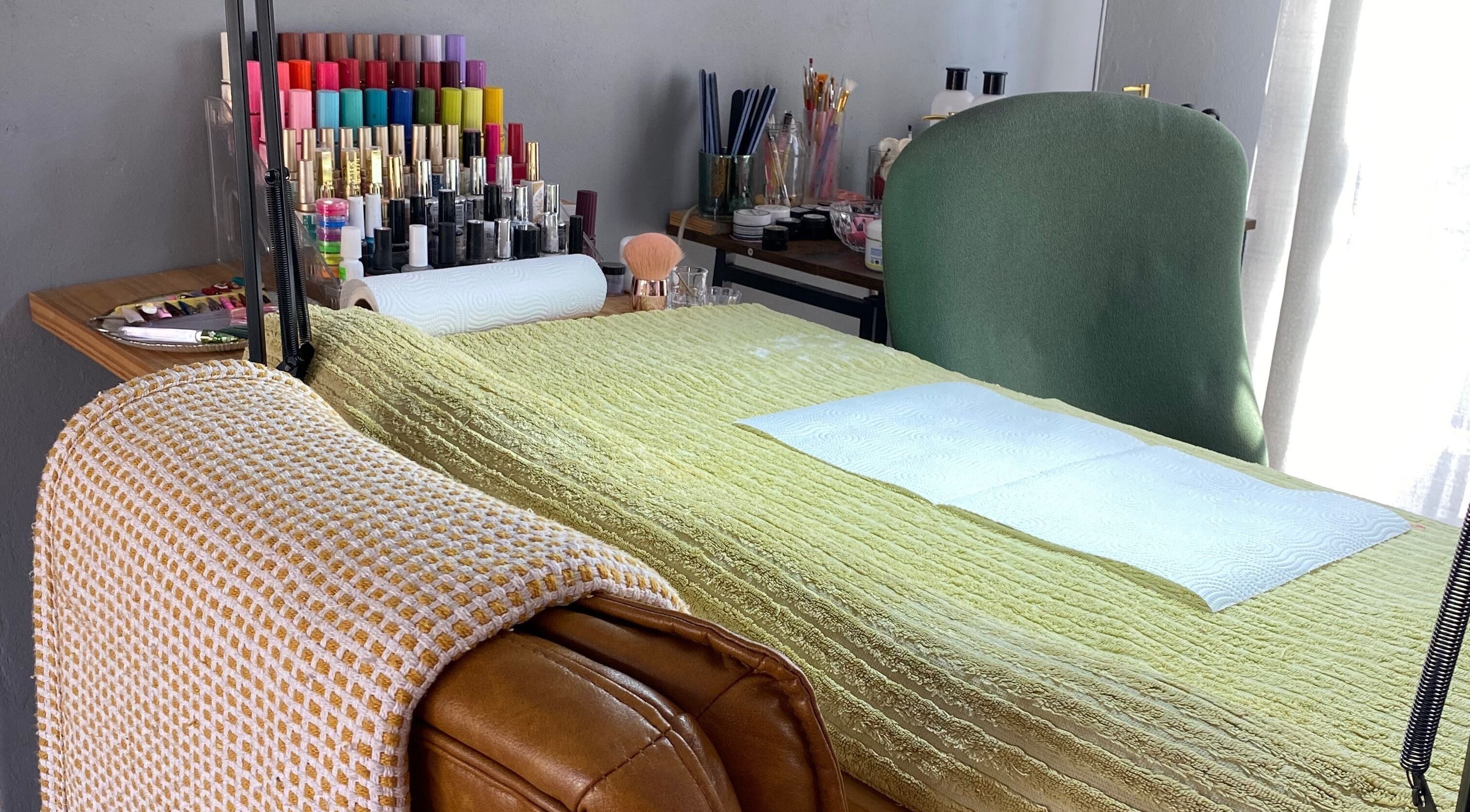 Manicure station at Clawed._ showcasing vibrant nail polishes in Akasia, Gauteng, ZA.