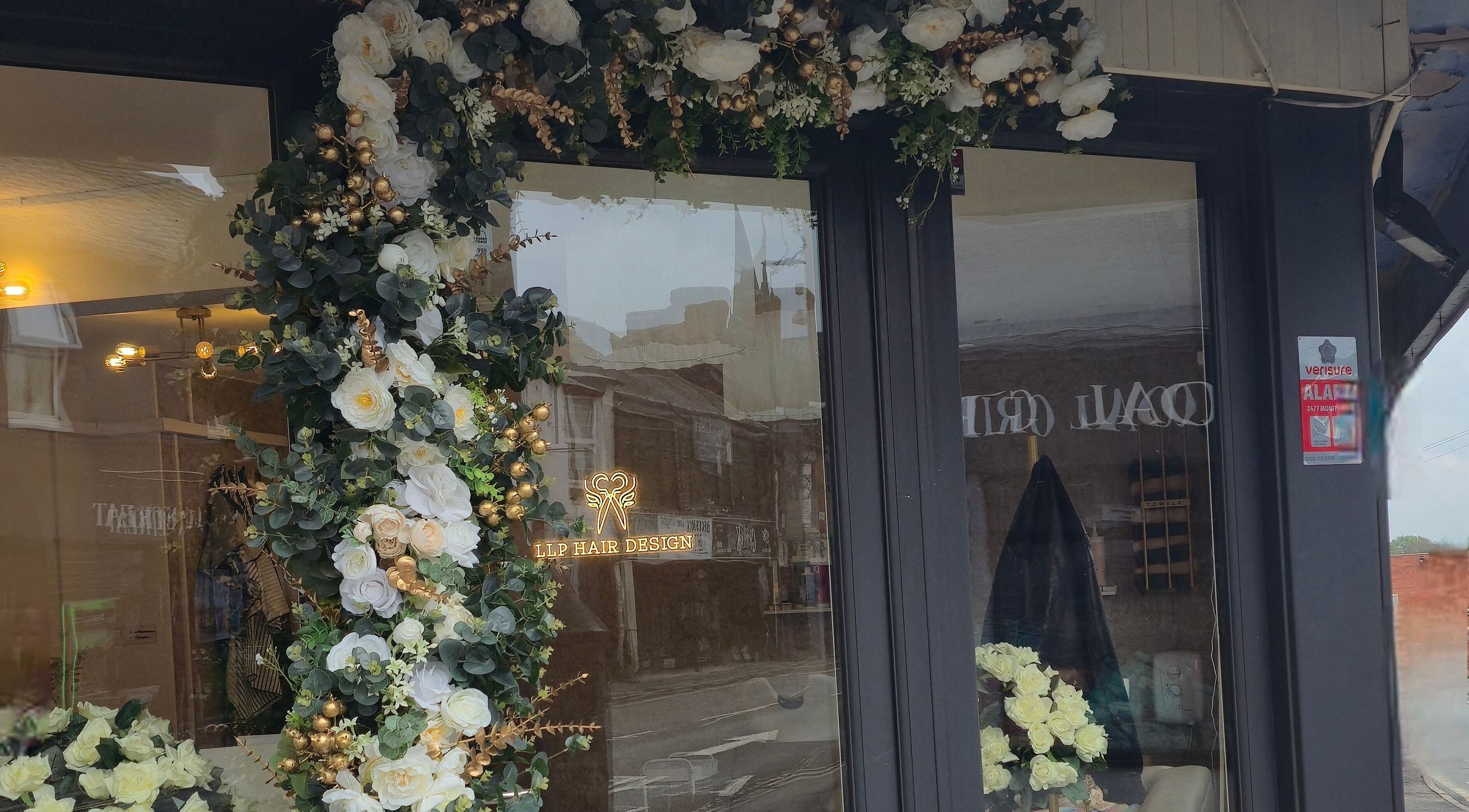LLP hair design facade adorned with lush floral decor in Clay Cross, England, GB.