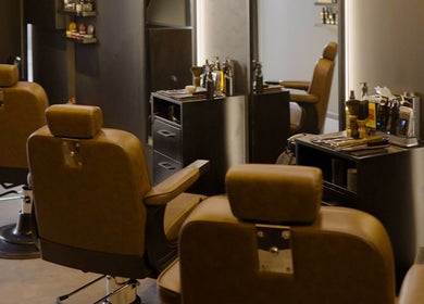 Chic interior of Brocave Groomers in Dubai, Dubai, AE showcasing stylish barber chairs and grooming tools.