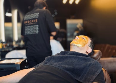 Facial treatment at Brocave Groomers in Dubai, Dubai, AE. Man relaxing with mask in modern grooming chair.