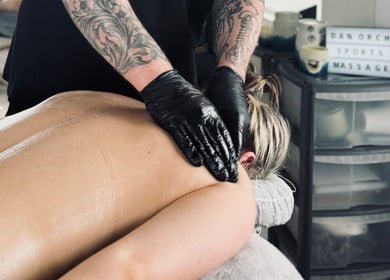 Massage therapist at Dan Orchard Sports Massage in Exeter, England, delivering a rejuvenating back massage.