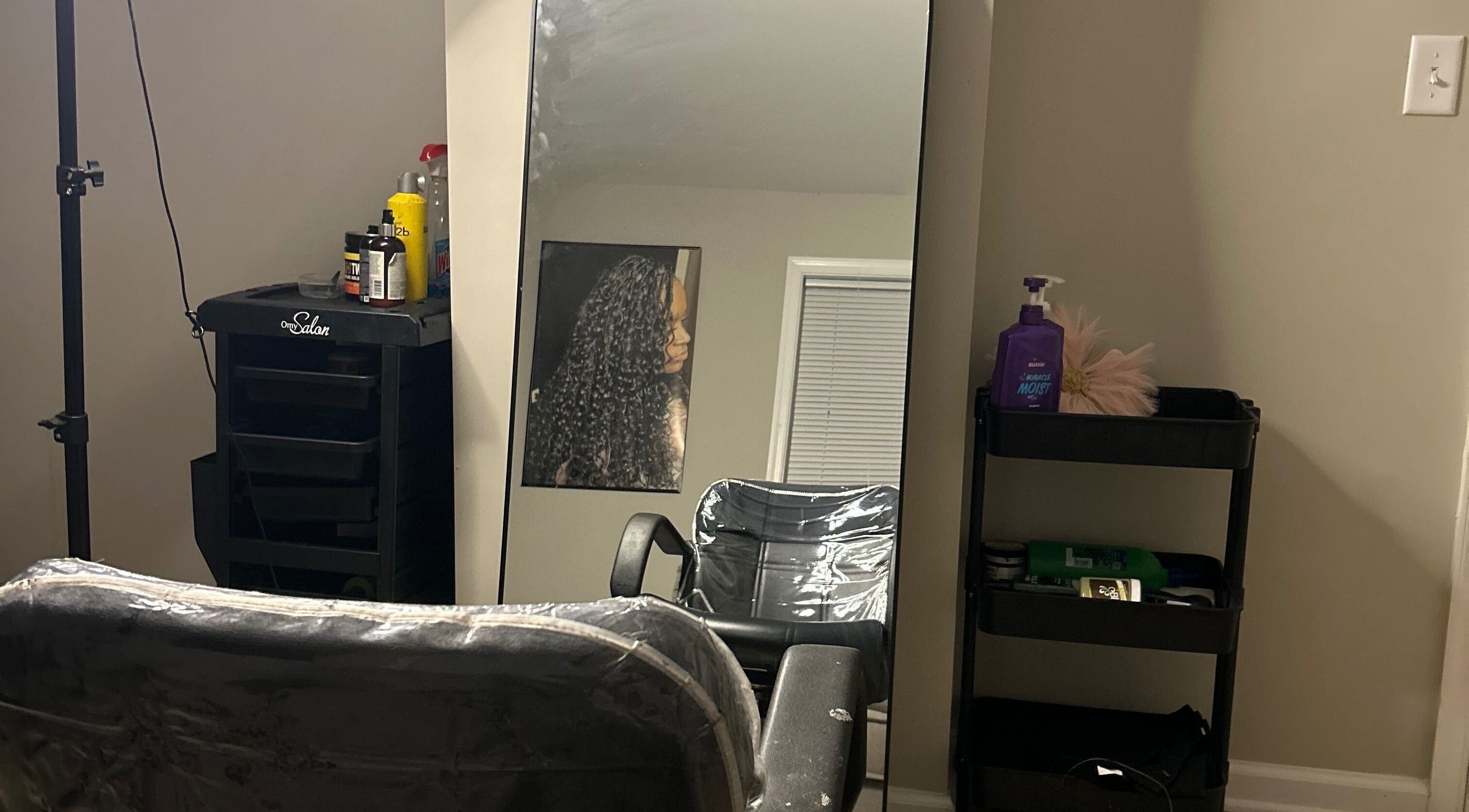 ExclusiveBeautyStudio interior with salon chair, mirror, and styling products in Salisbury, Maryland, US.