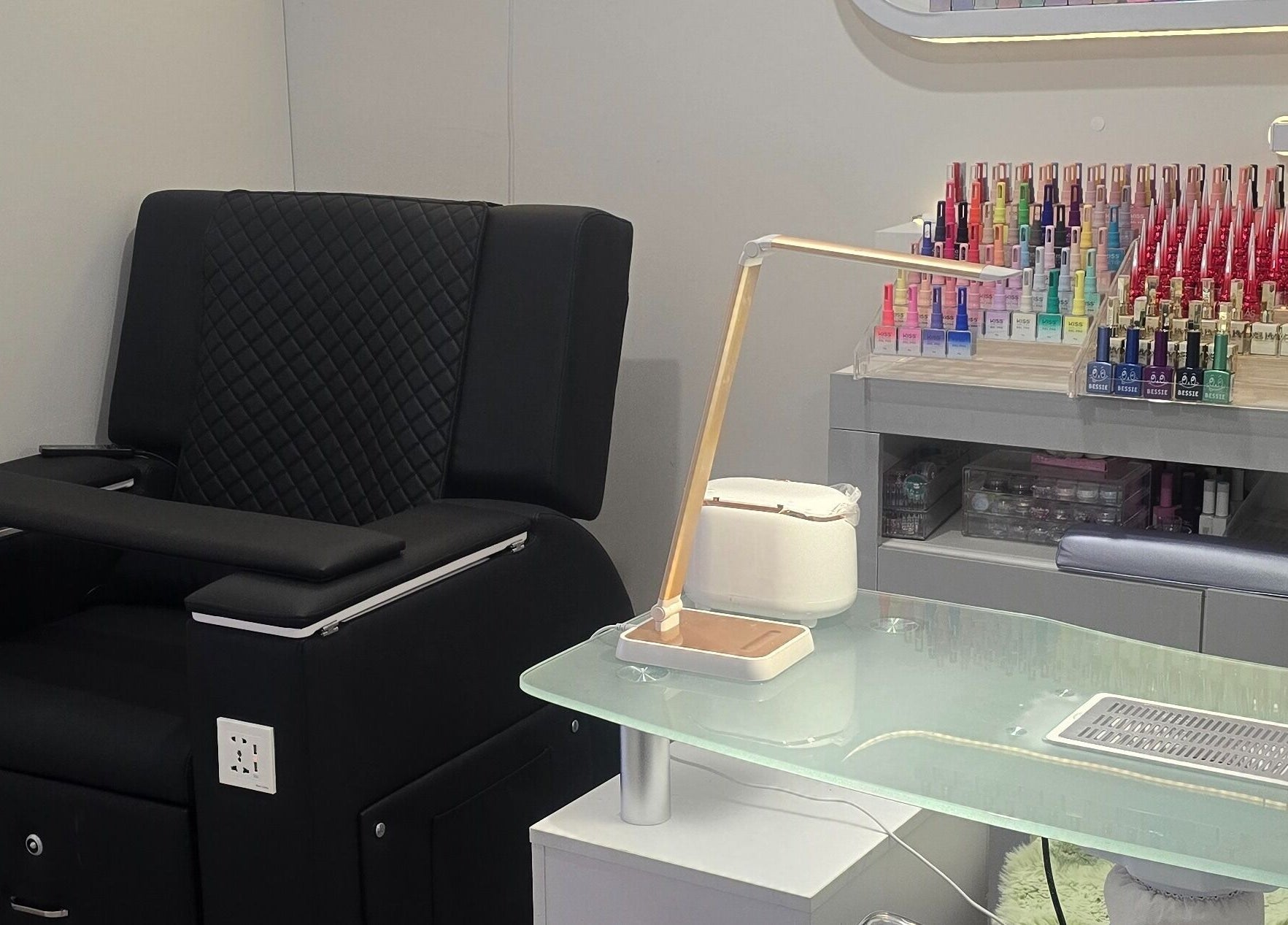 Modern nail station at Bella's Beauty, Christchurch, Canterbury Region, NZ, featuring colorful polish display.